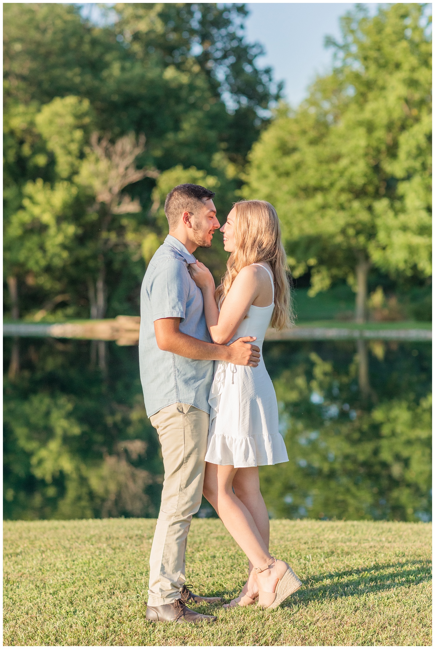 couple standing next to a pond at engagement session in Green Springs