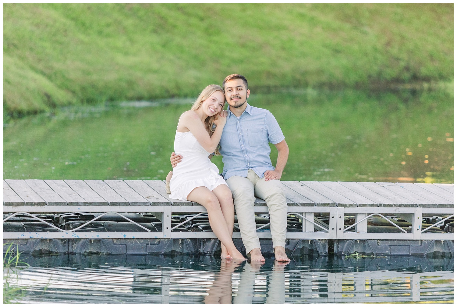 couple sitting on a dock barefoot at engagement session in Green Springs, Ohio
