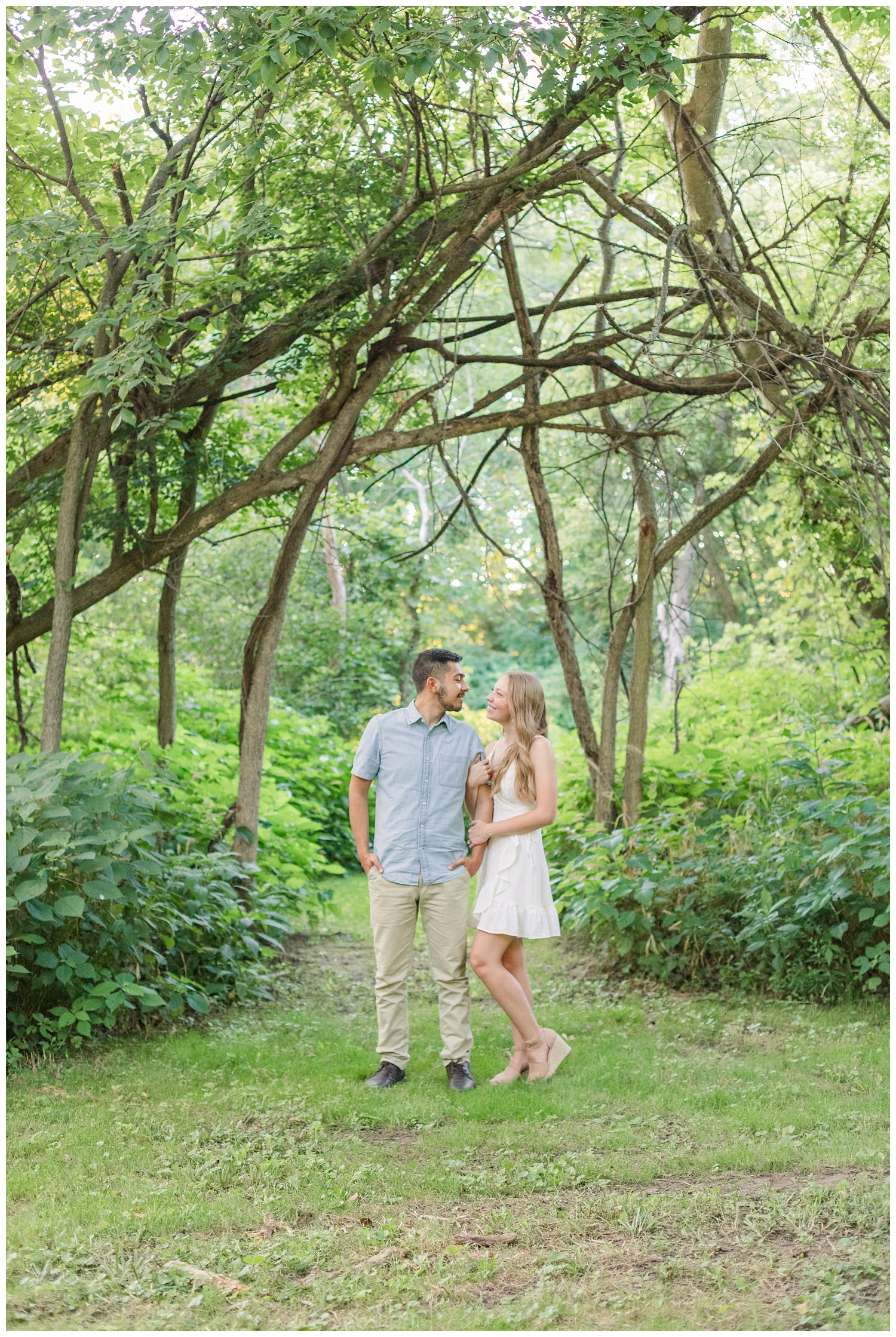 couple standing together in the woods at engagement session in Green Springs, Ohio