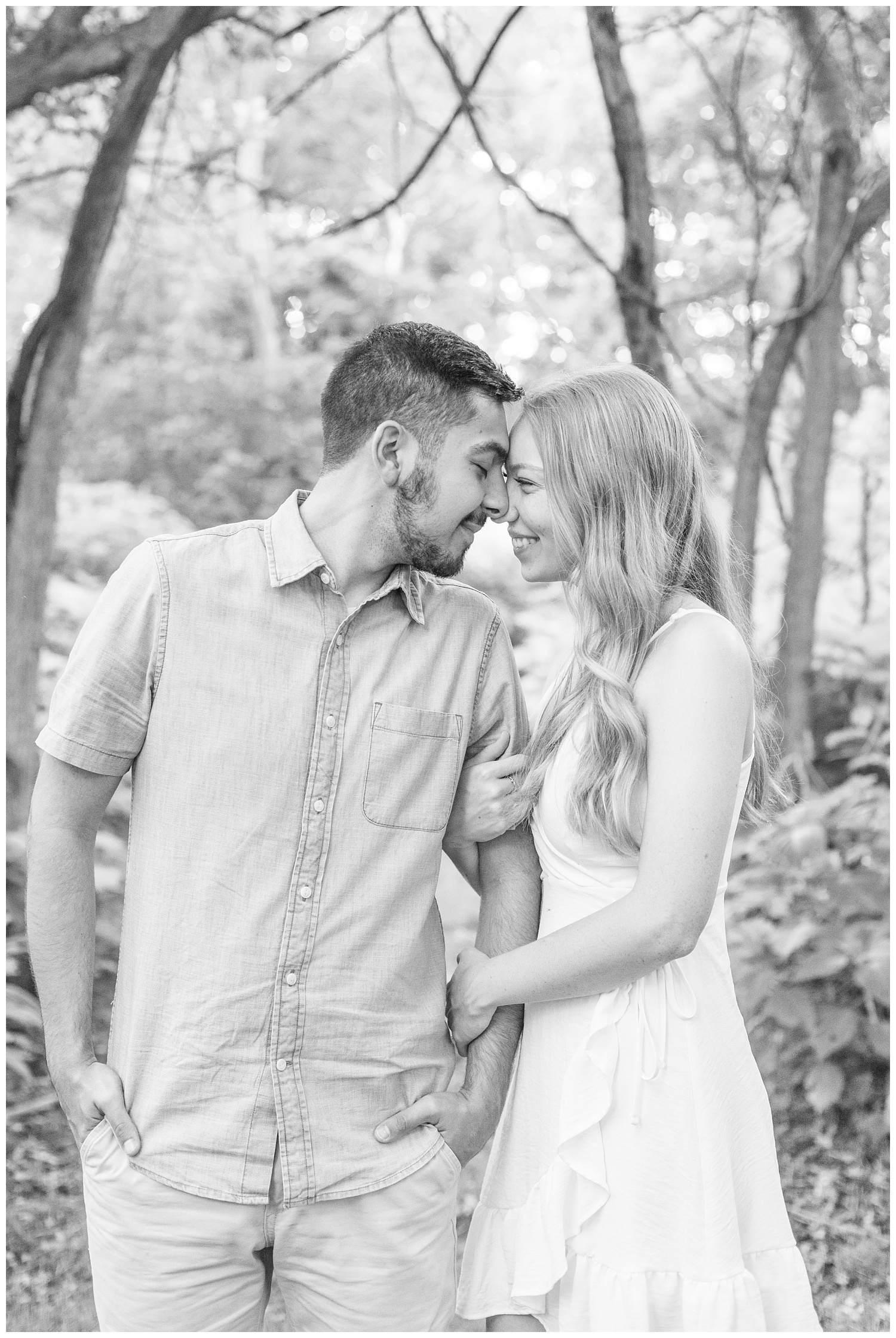 couple touching noses in the woods at Ohio engagement session