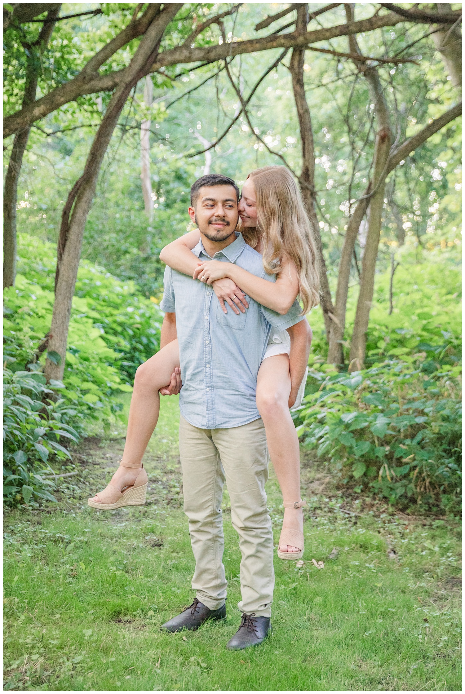 couple piggy backing at engagement session in Ohio