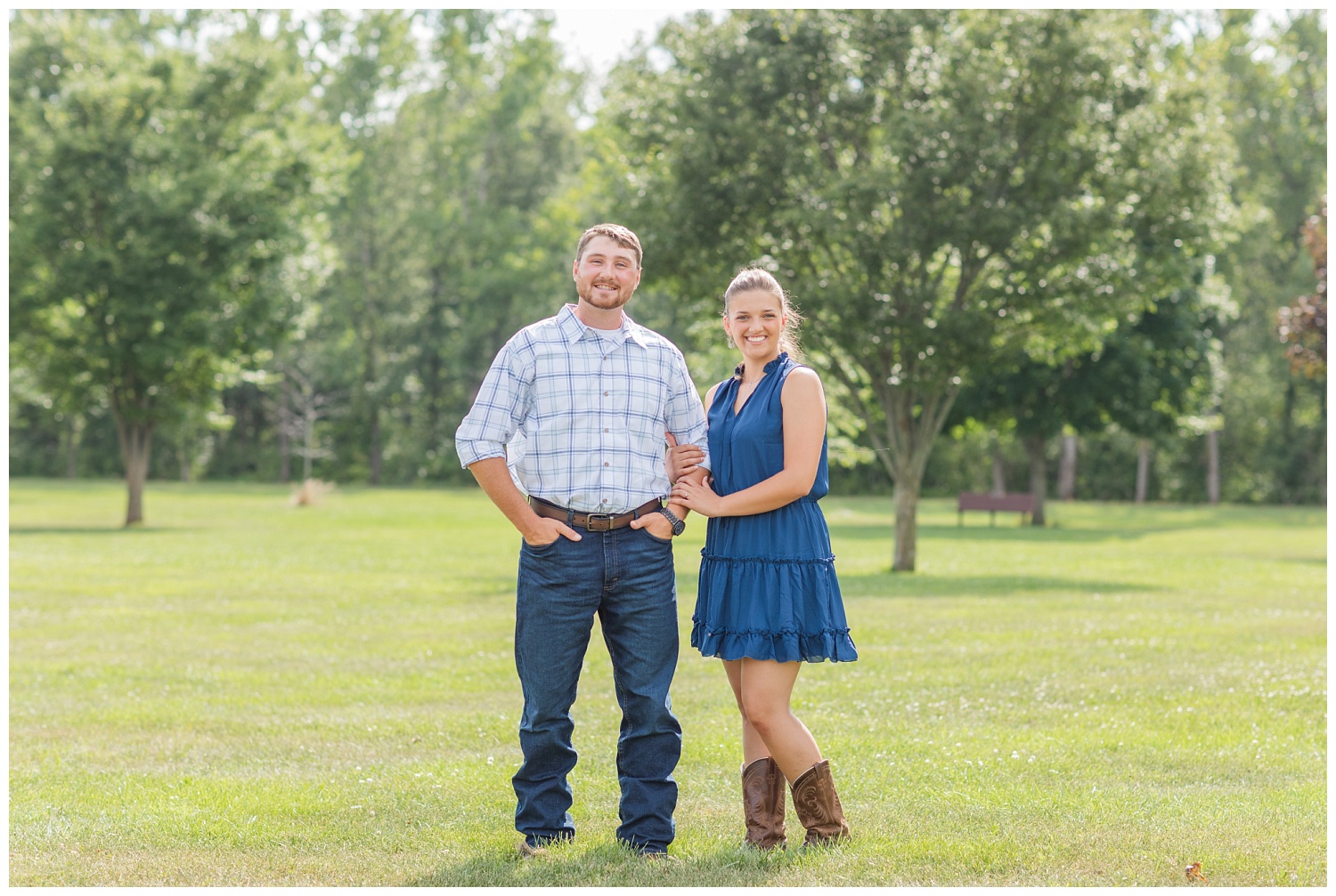 engaged couple posing for photos in a field in Gibsonburg