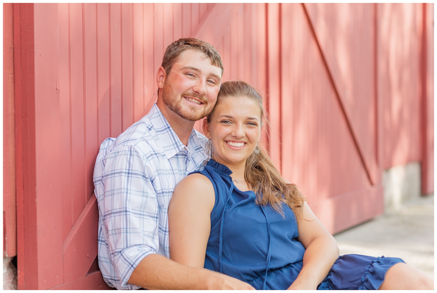 couple sitting next to a red barn in Ohio