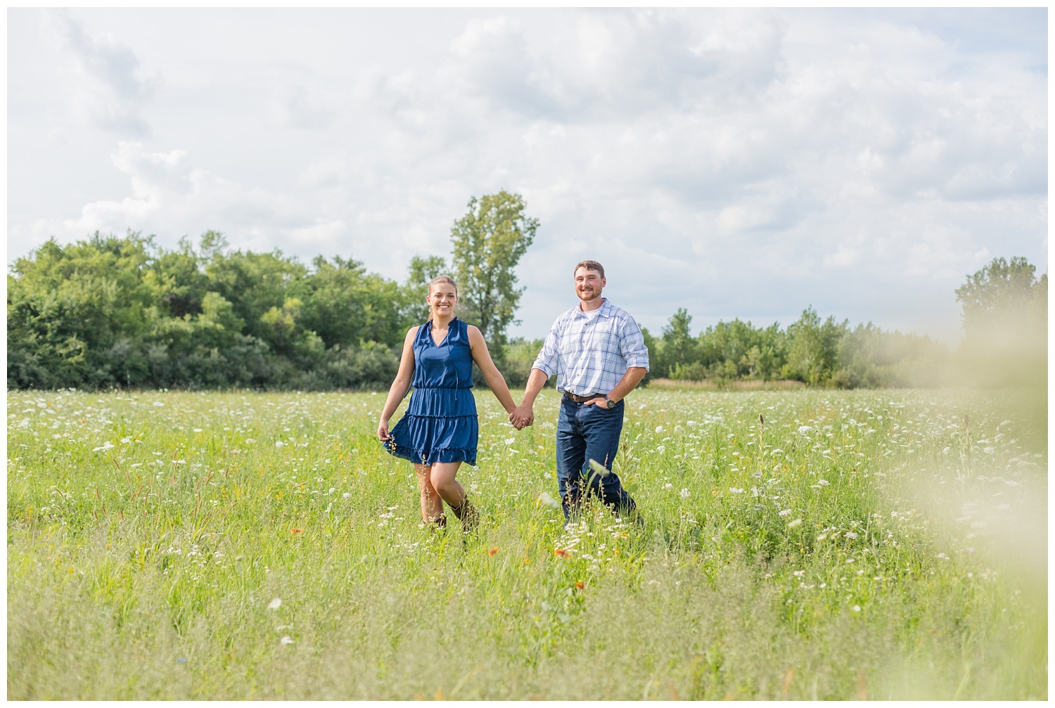 couple walking in a field at White Star Park engagement session