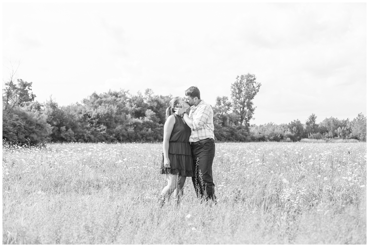 engaged couple kissing in a field in Gibsonburg, Ohio