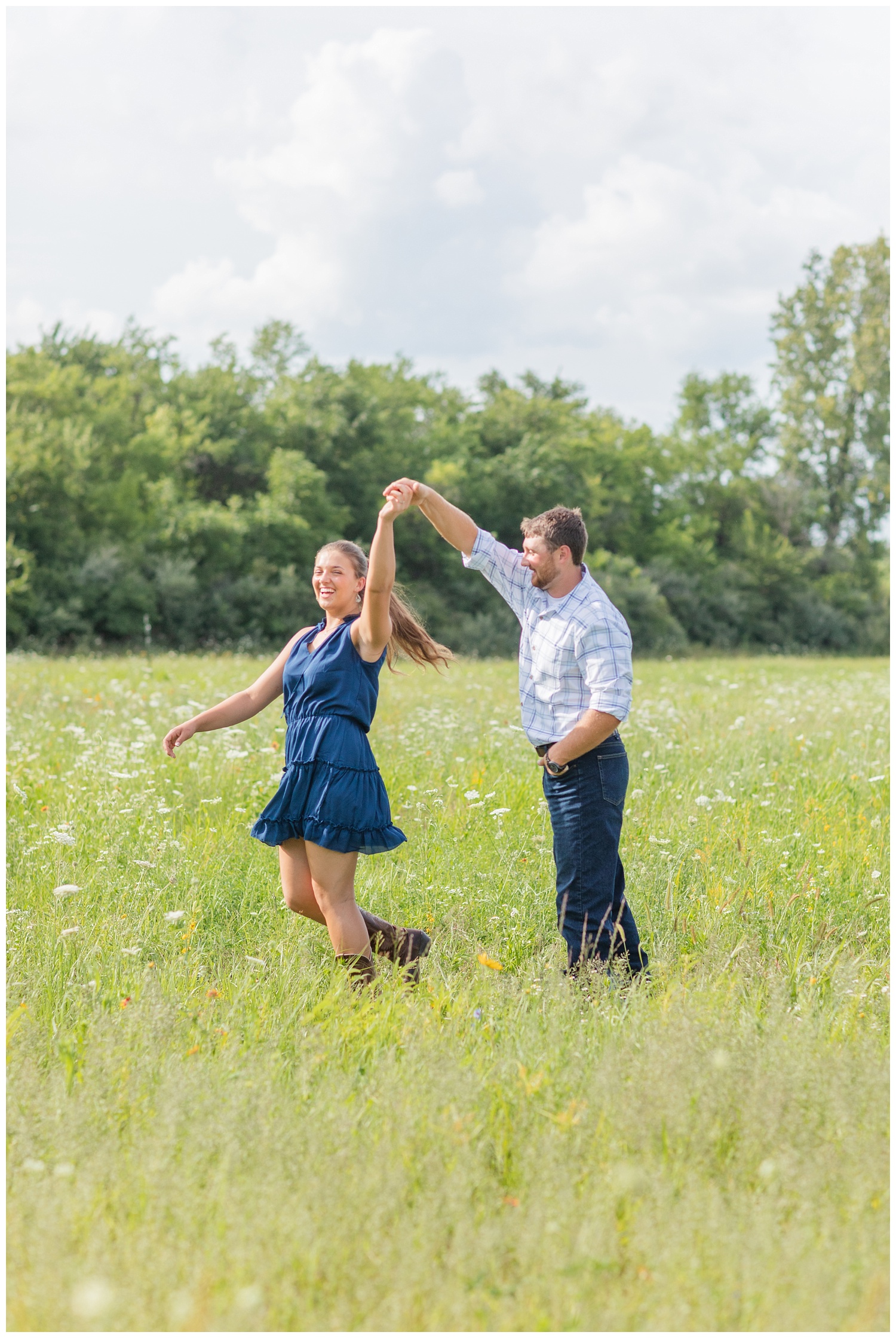 couple twirling in a white flower field in Gibsonburg Ohio