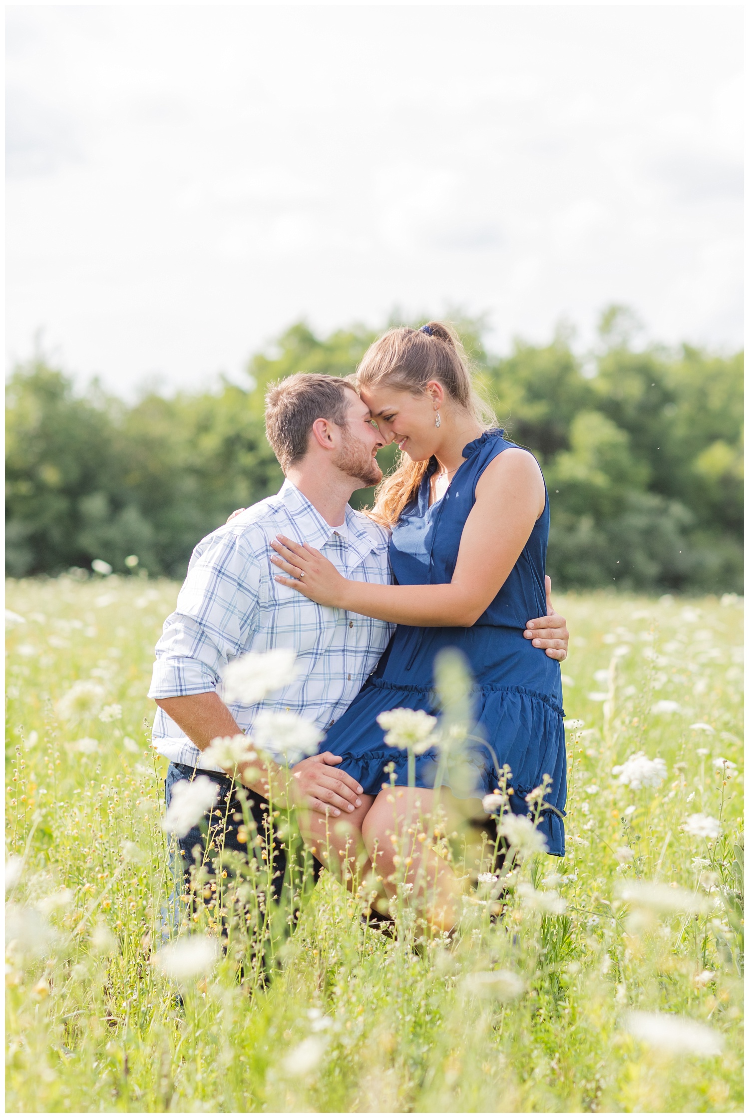 couple sitting in a white flower field at White Star Park