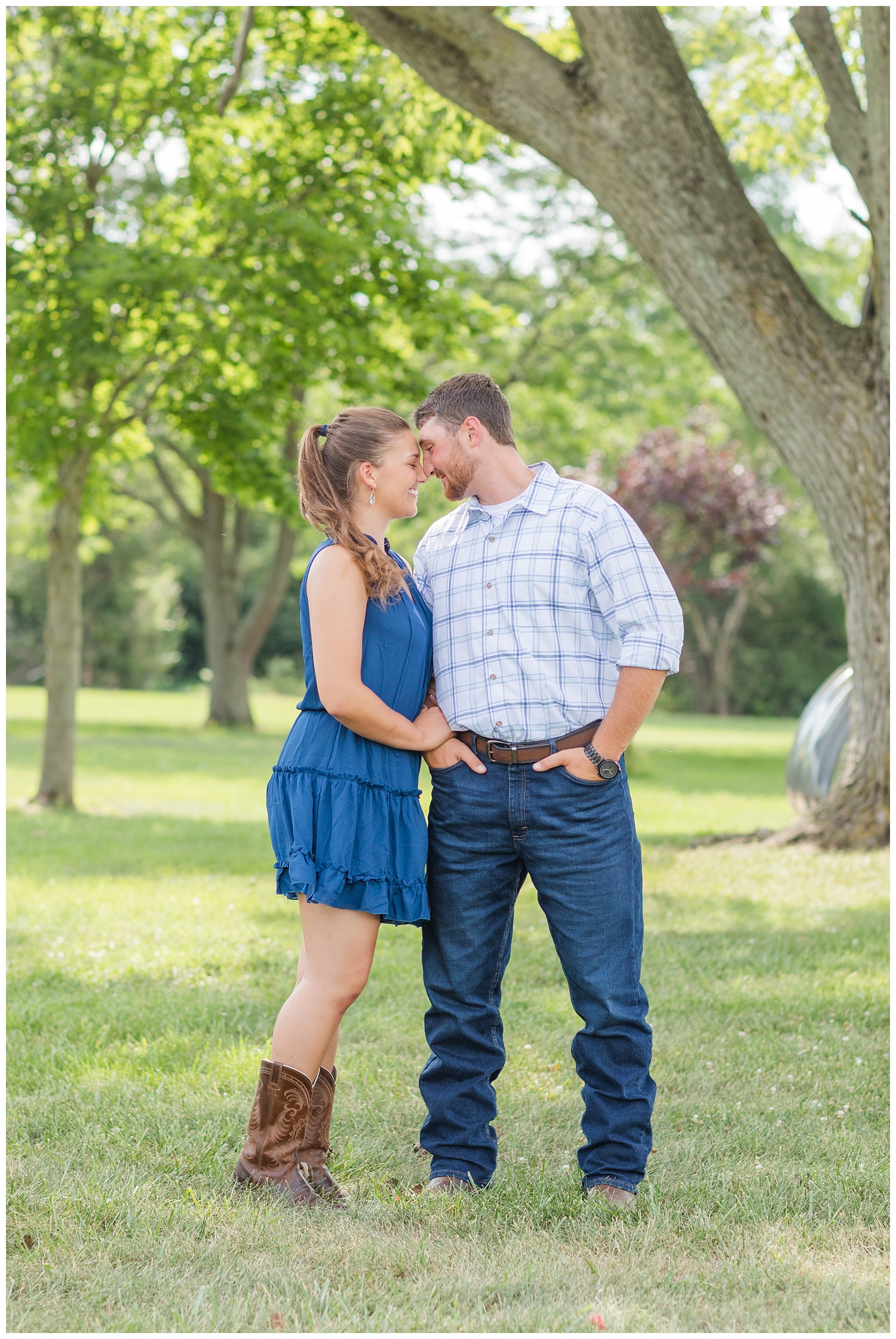 couple wearing cowboy boots and jeans at engagement session in Oho