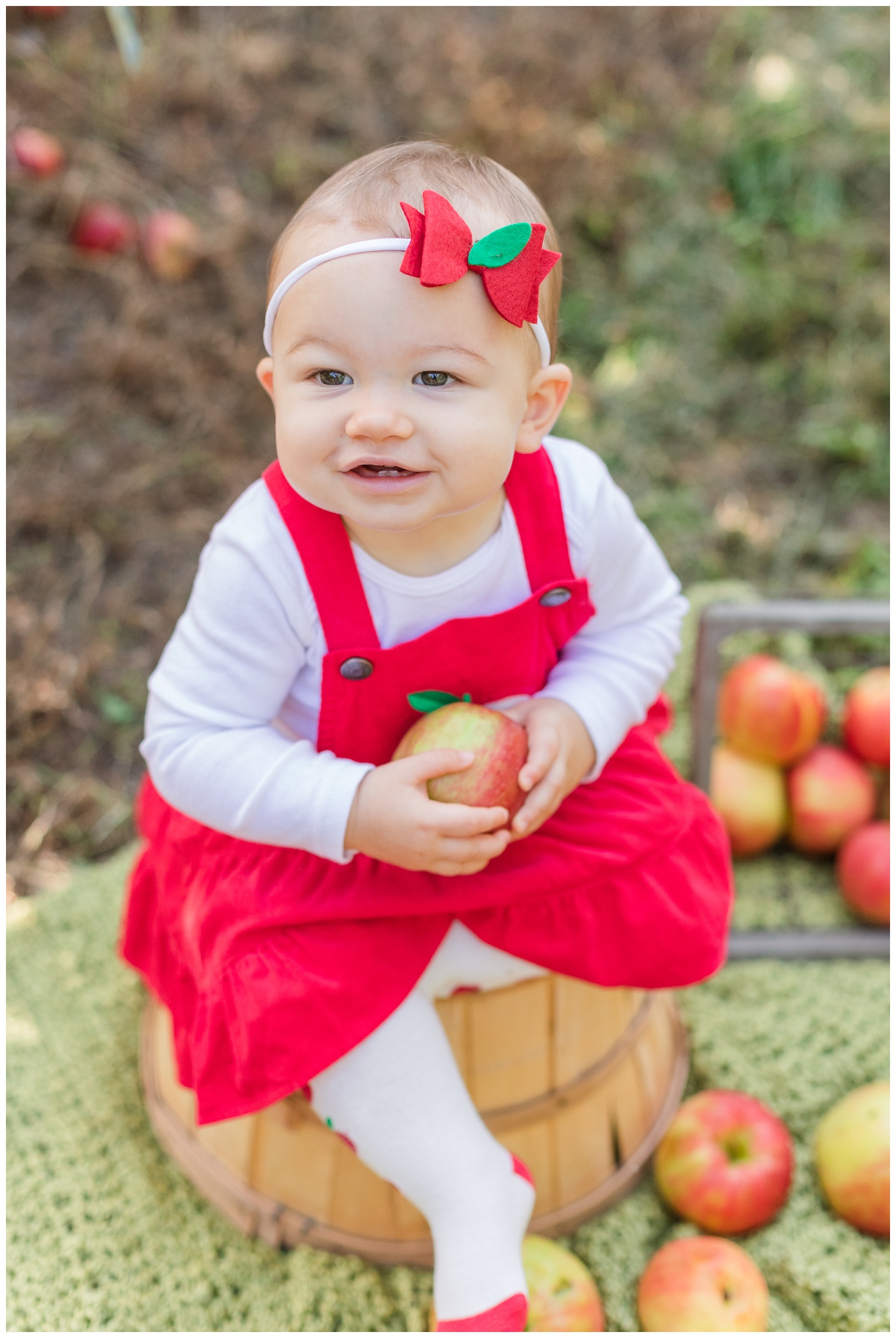 little girl wearing a red dress for cake smash session 