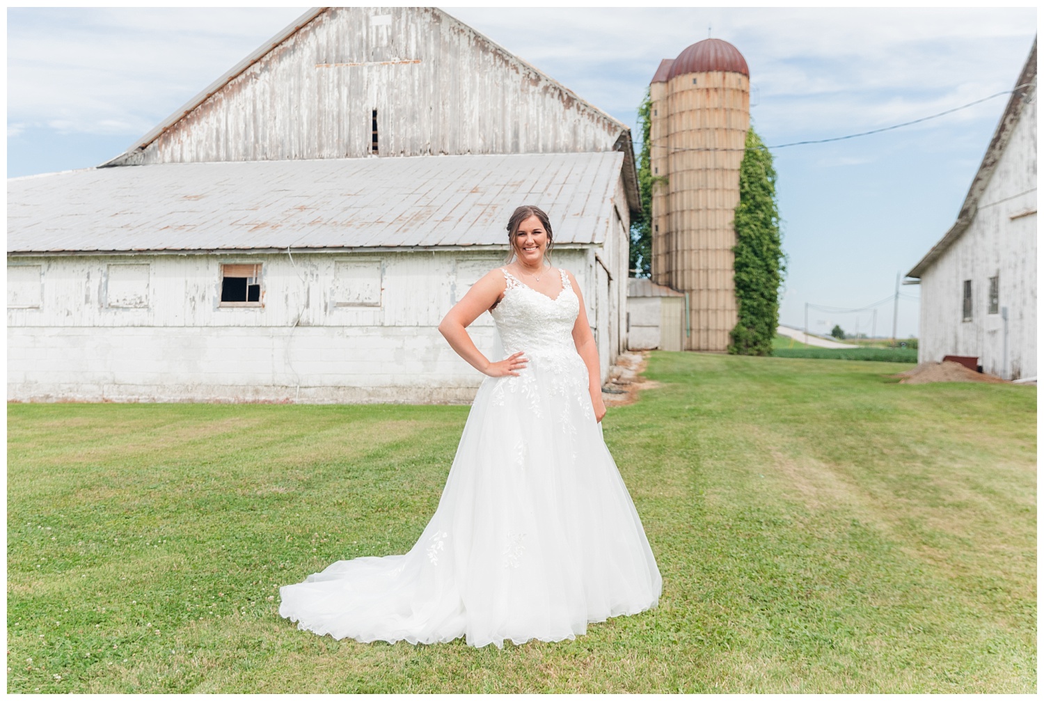 bride posing in front a white barn in Fremont, Ohio