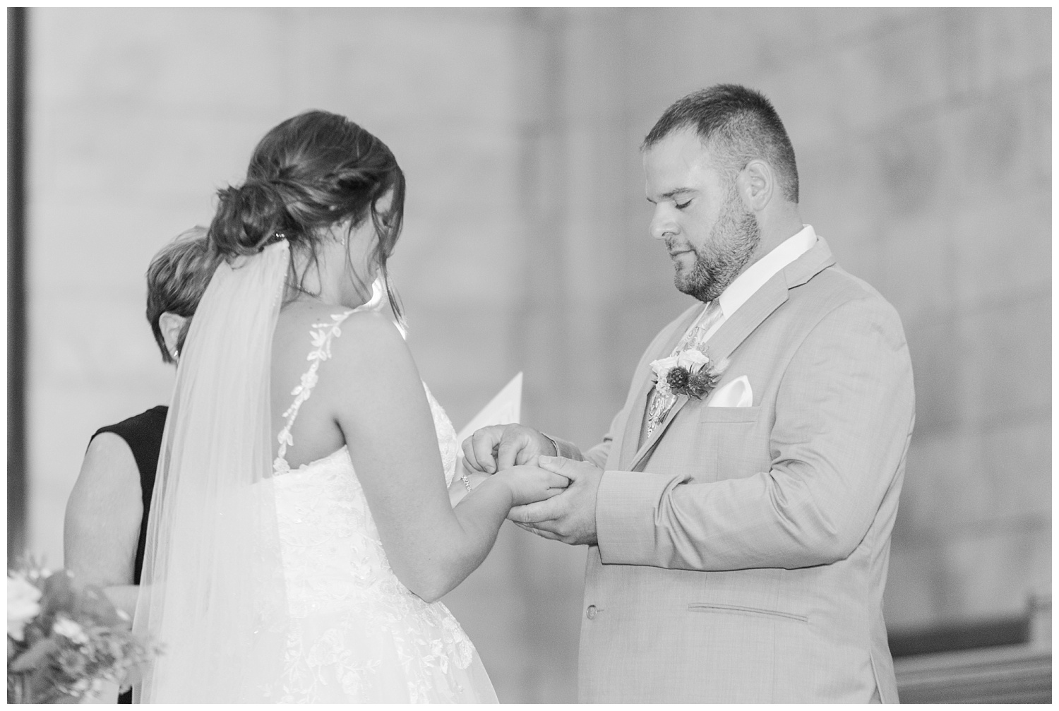 bride and groom exchanging rings at wedding in Ohio