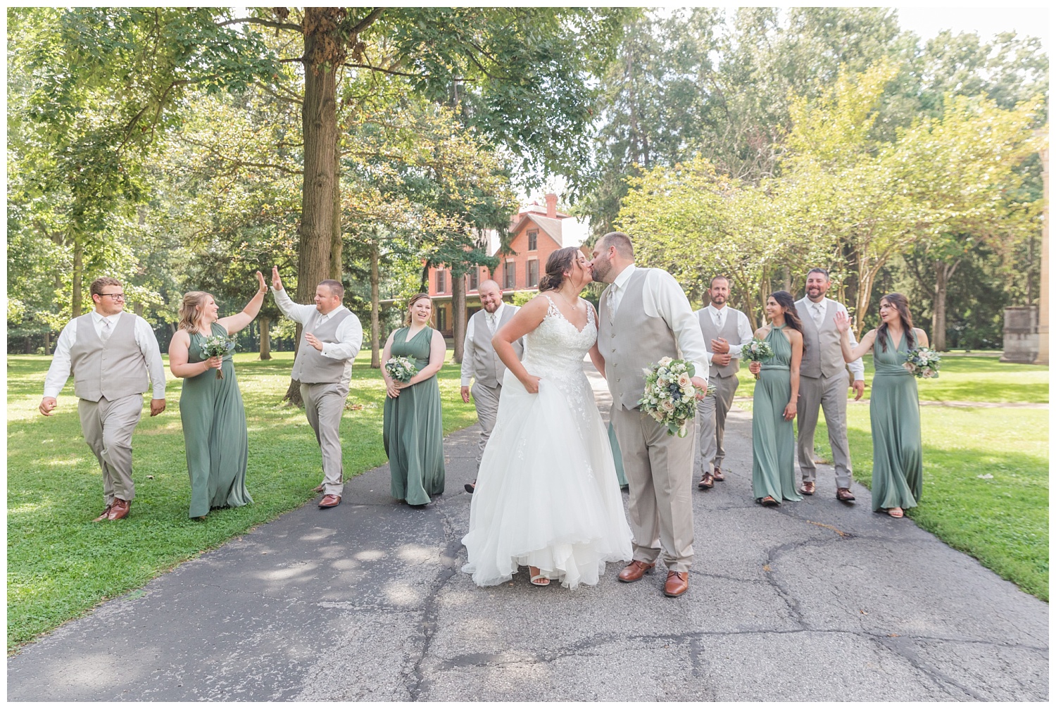full bridal party walking together in front of the Hayes Center