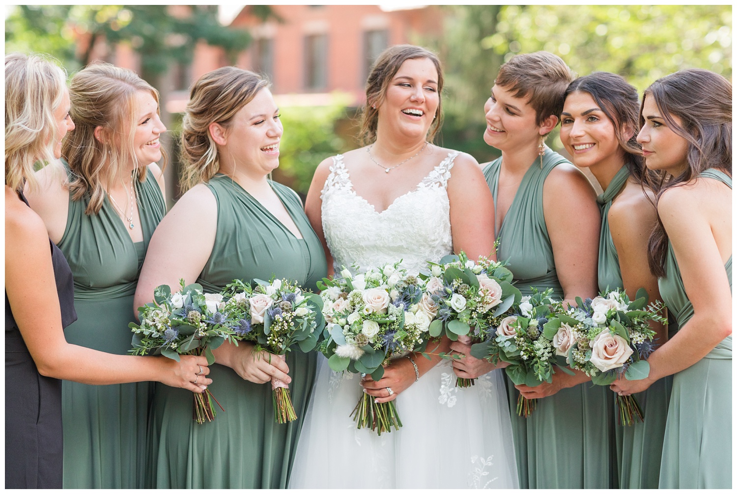 bride and bridesmaids laughing together outside at the Hayes Center