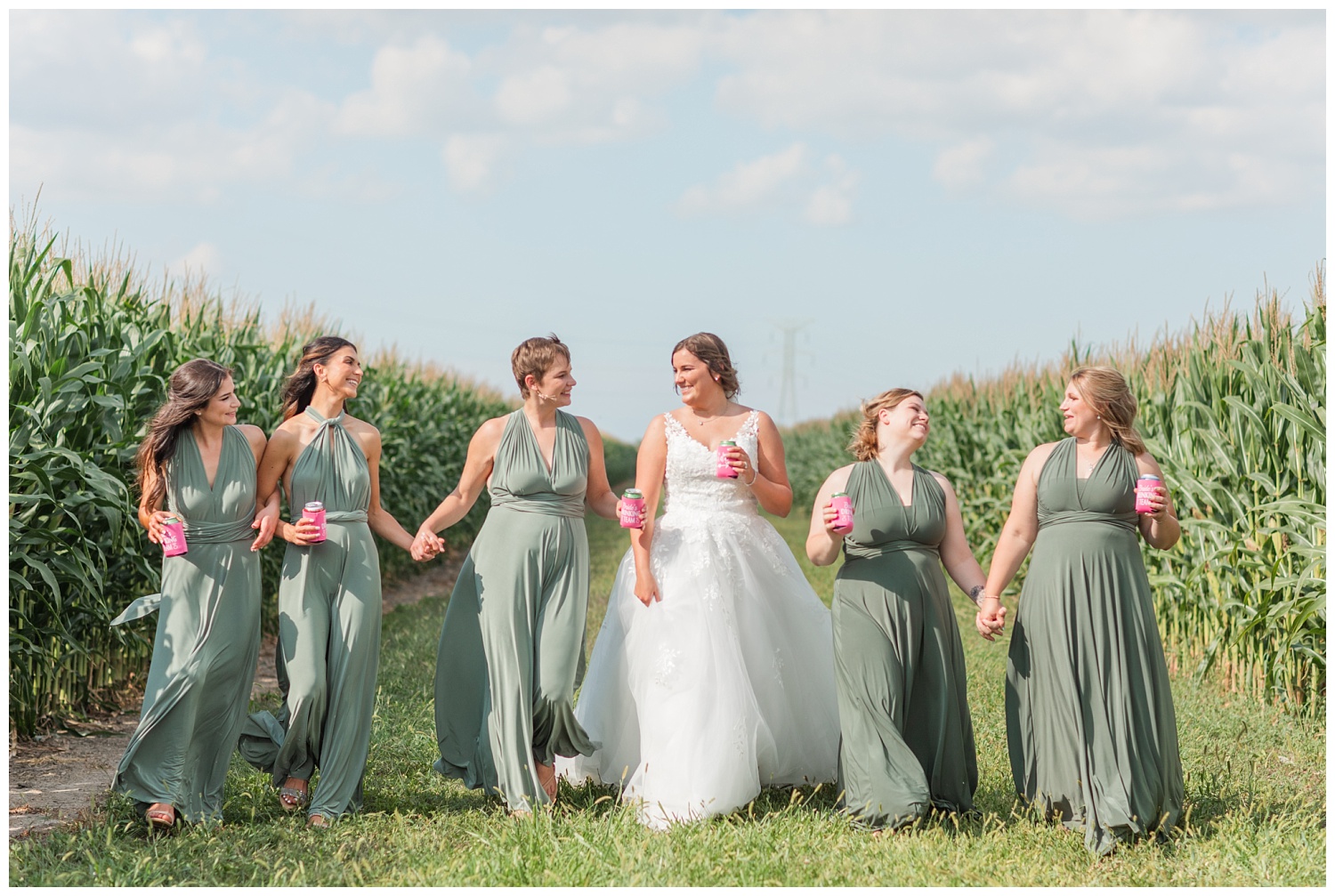 bridal party walking through corn fields