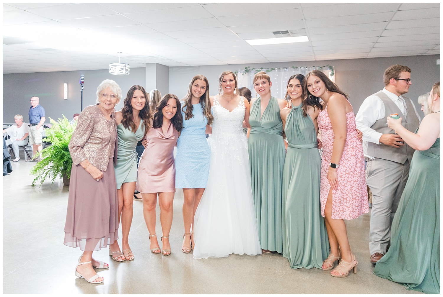 bride posing with reception guests at the Victors Event Center in Fremont, Ohio