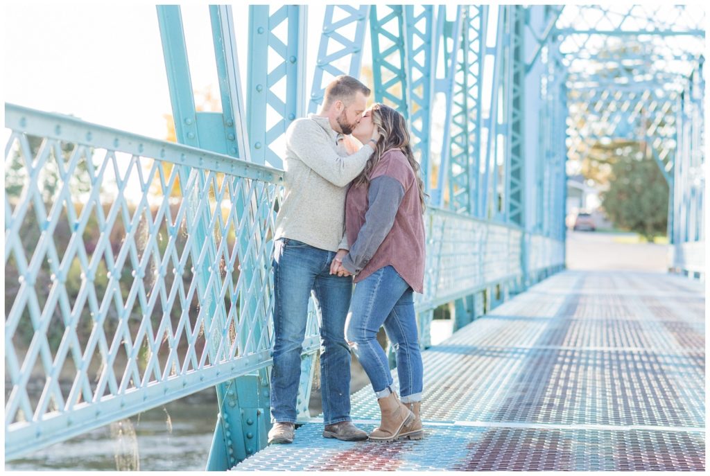 engaged couple kissing on the Tindall Bridge in Ohio