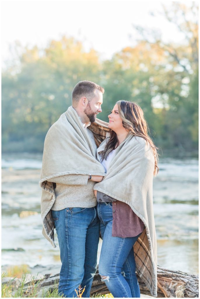 couple wrapped up in a blanket standing next to the river in Fremont, Ohio