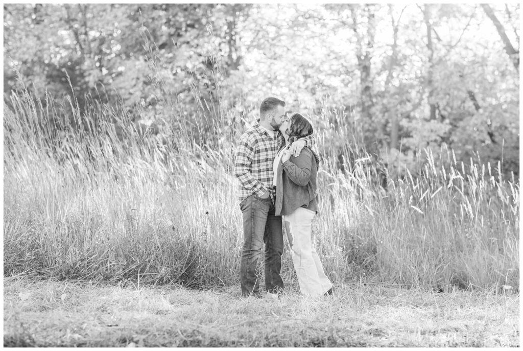 engaged couple kissing in the field at  Chudzinski Johannsen Park
