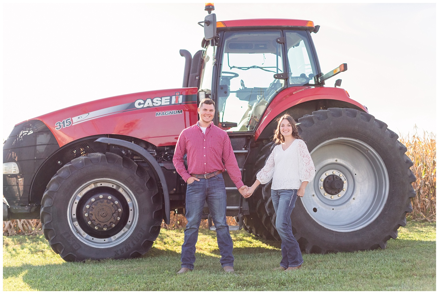 engaged couple standing in front of a red tractor