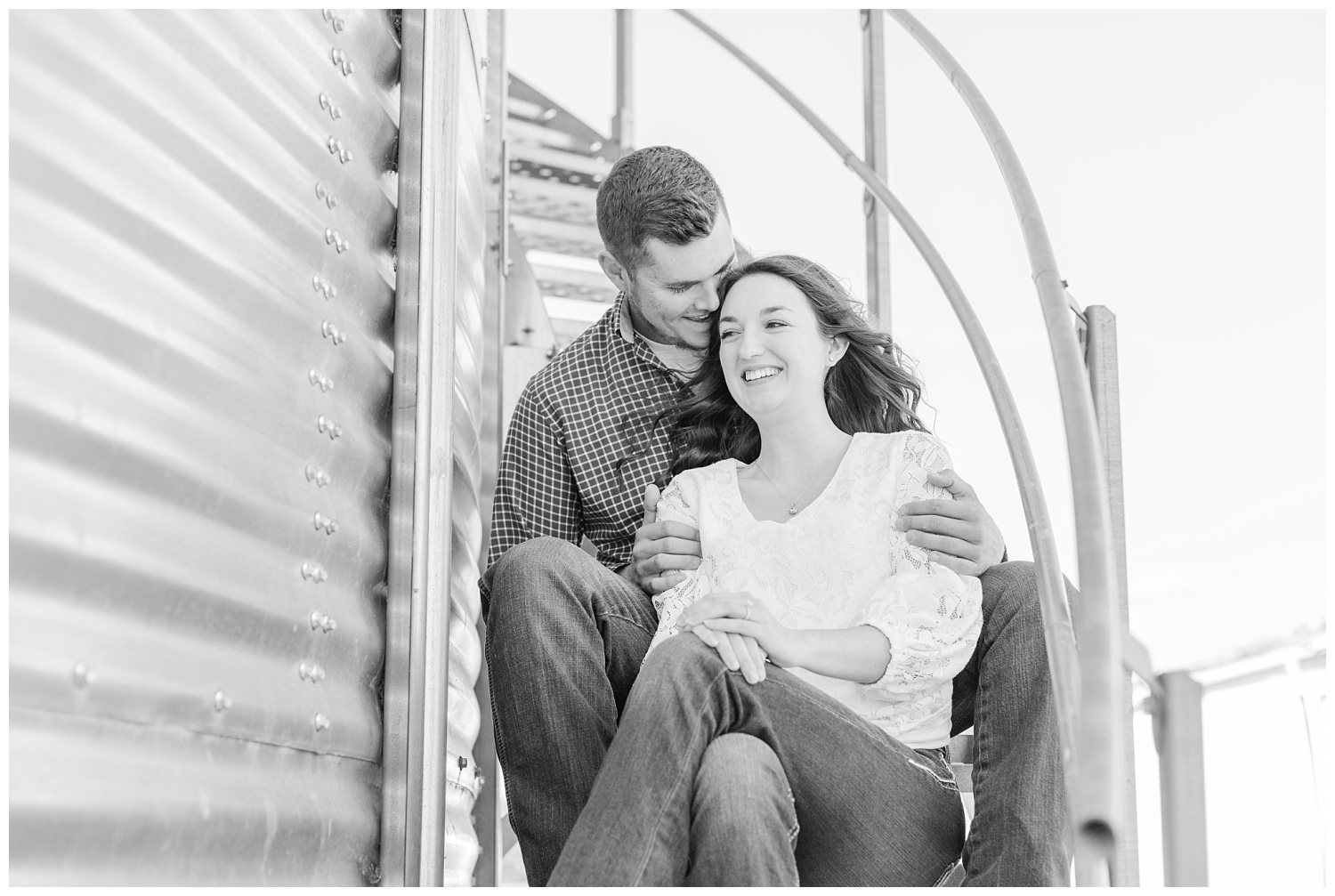 couple sitting on the stairs of a silo
