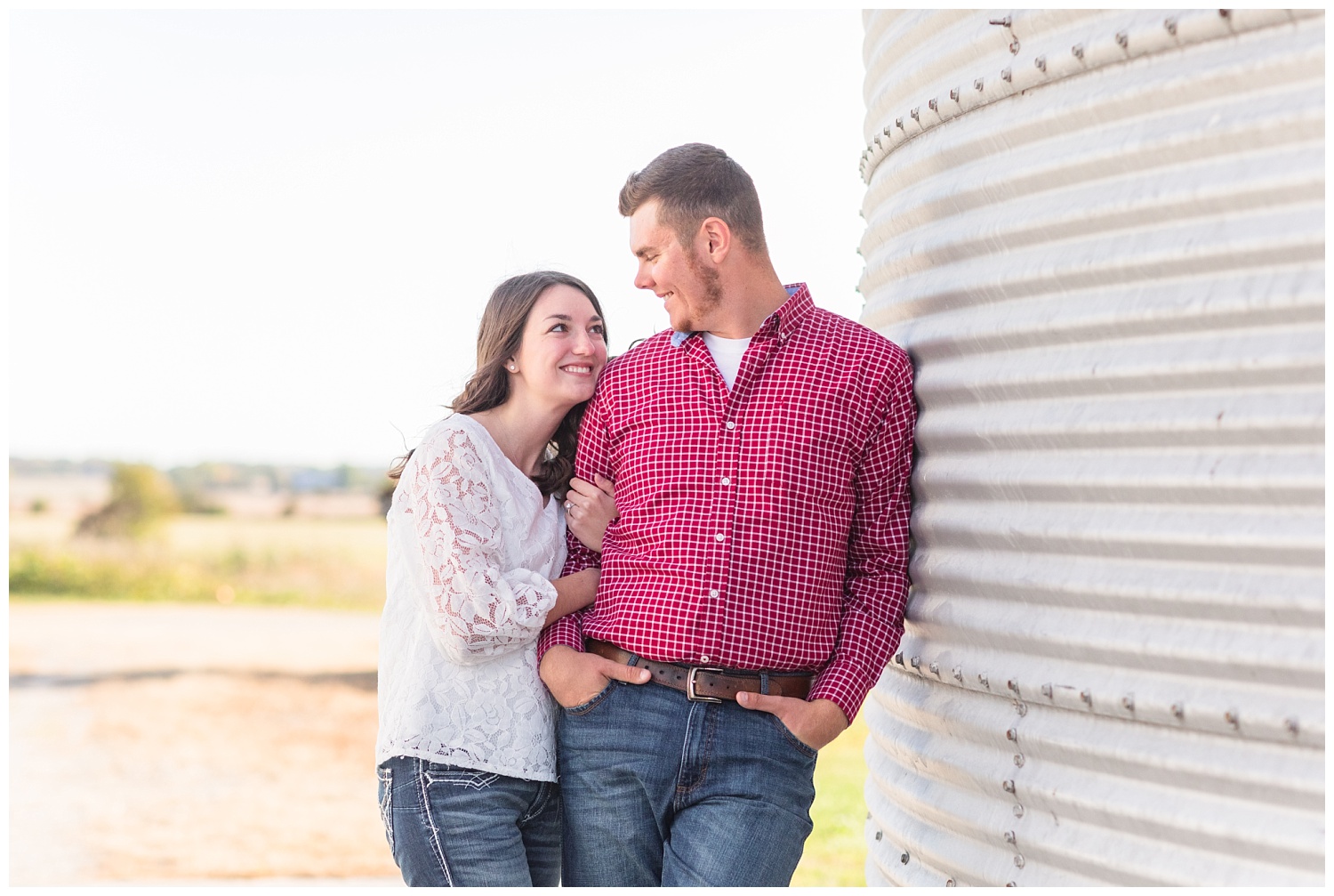 engaged couple standing next to a silo in Ohio