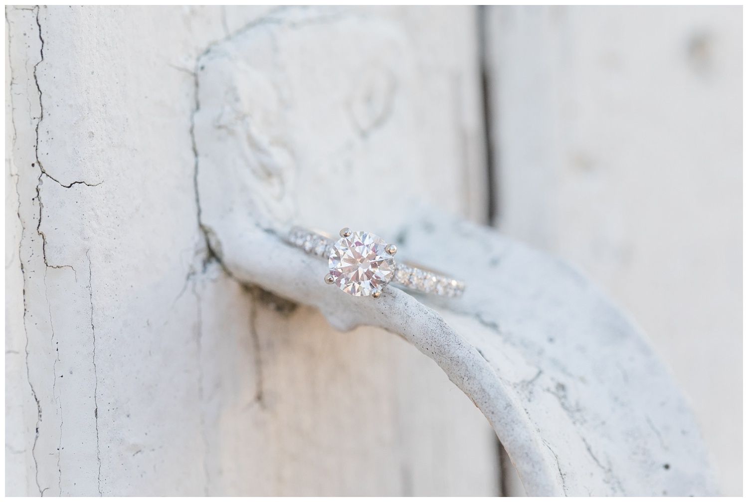 an engagement ring sitting on top of a white door handle