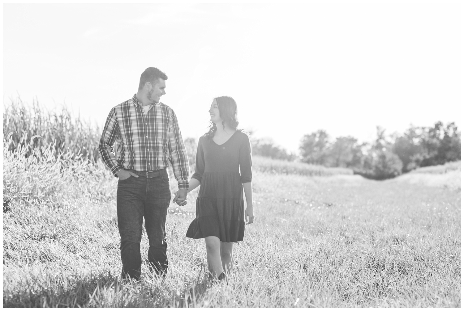 engaged couple walking together in a corn field in northwest Ohio