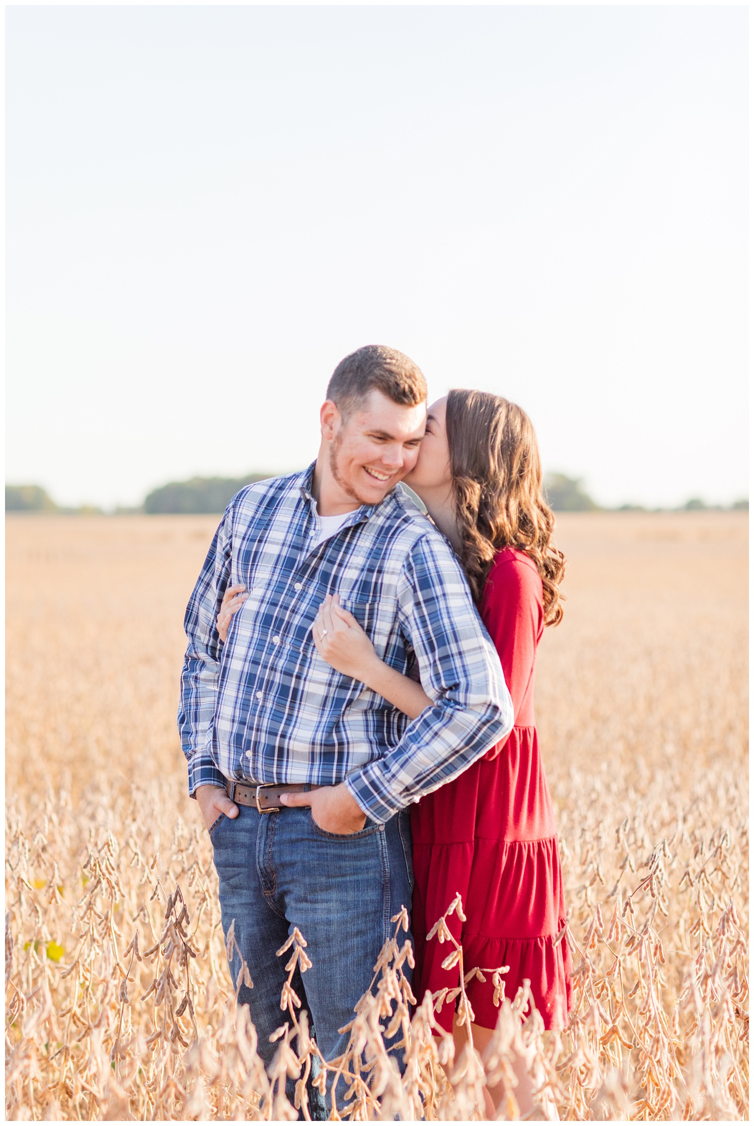 engaged couple standing in a corn field in northwest Ohio