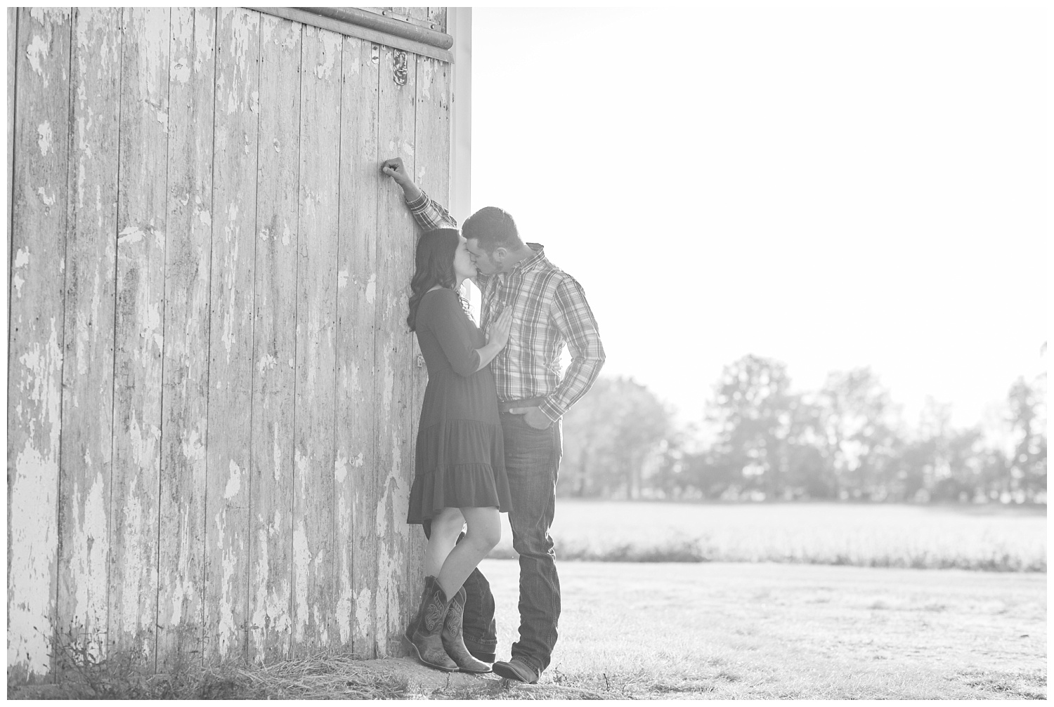 couple standing in front of a gray barn in Ohio