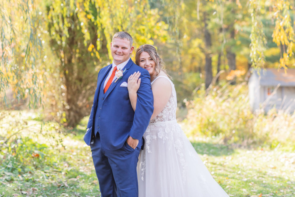 husband and wife posing together for a a gorgeous fall wedding in Fostoria, Ohio