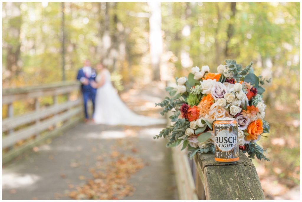 a bouquet and a beer can sitting on a rail of a bridge in Ohio