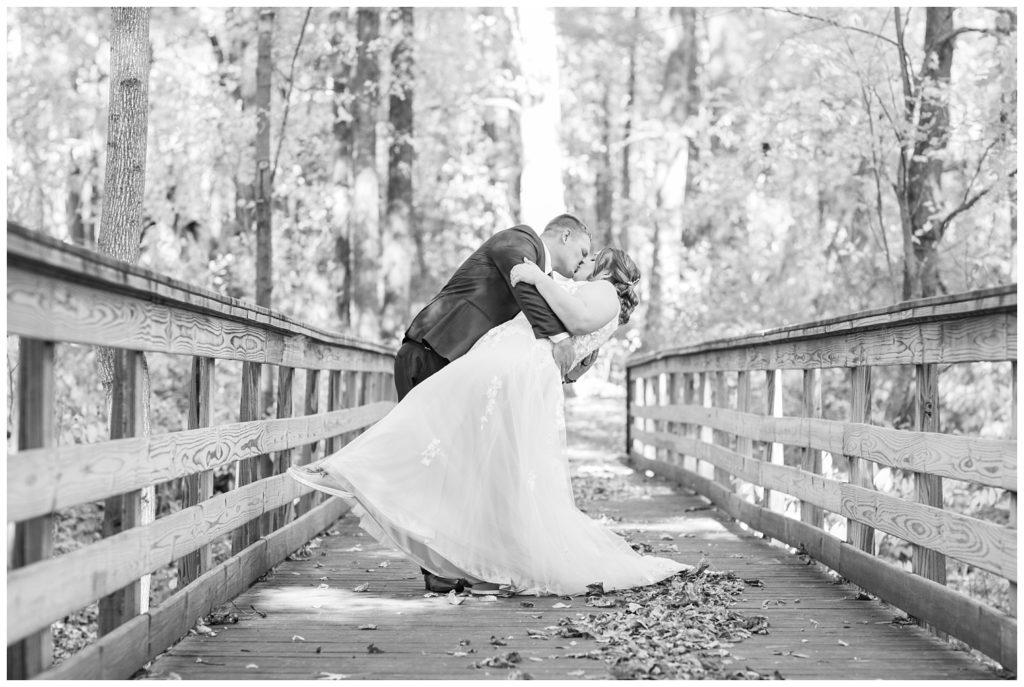 groom dipping the bride for a kiss on a bridge in Fostoria, Ohio