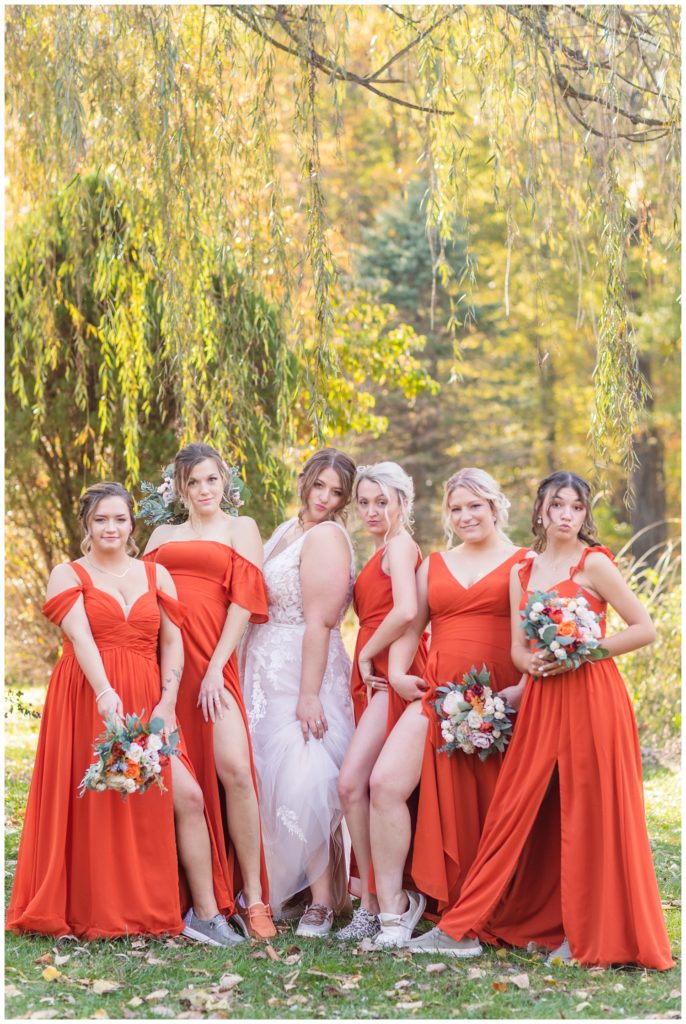 bride and bridesmaids posing together showing their legs
