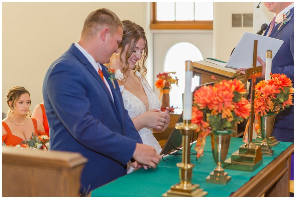 bride and groom kneeling at the altar at church in Fostoria, Ohio