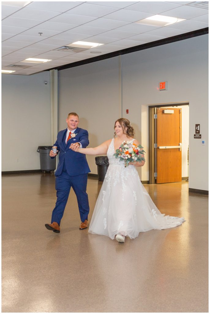 bride and groom make entrance into reception