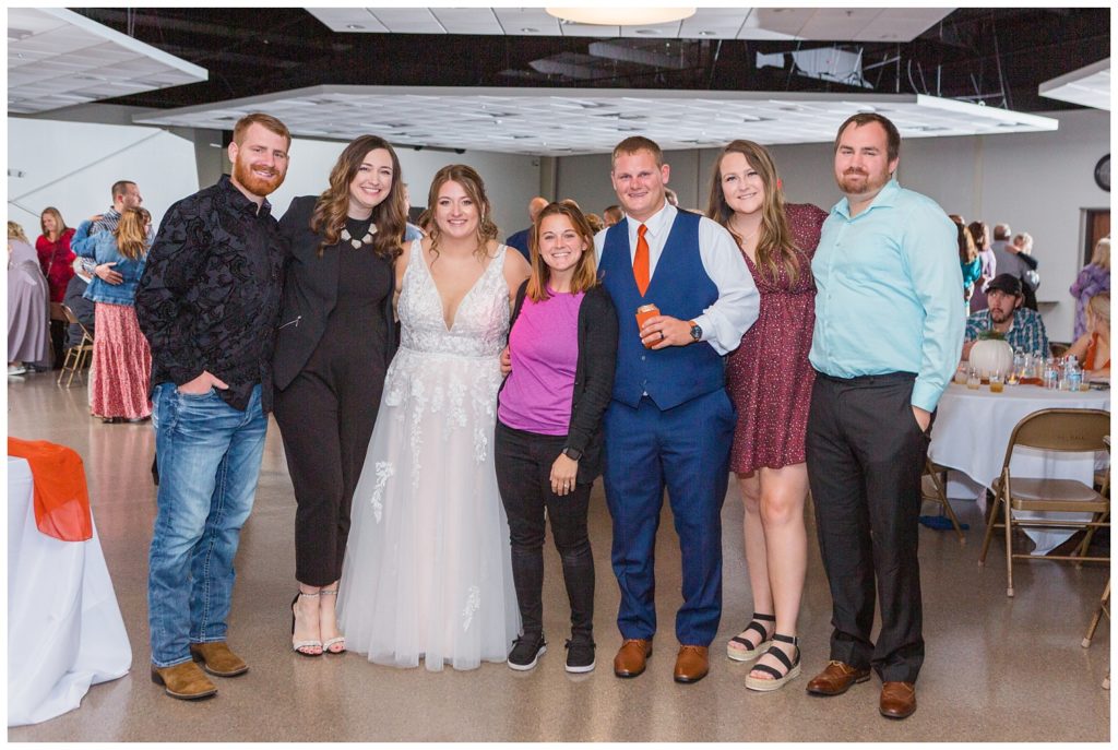 wedding photographer posing with former wedding couples in Fostoria, Ohio