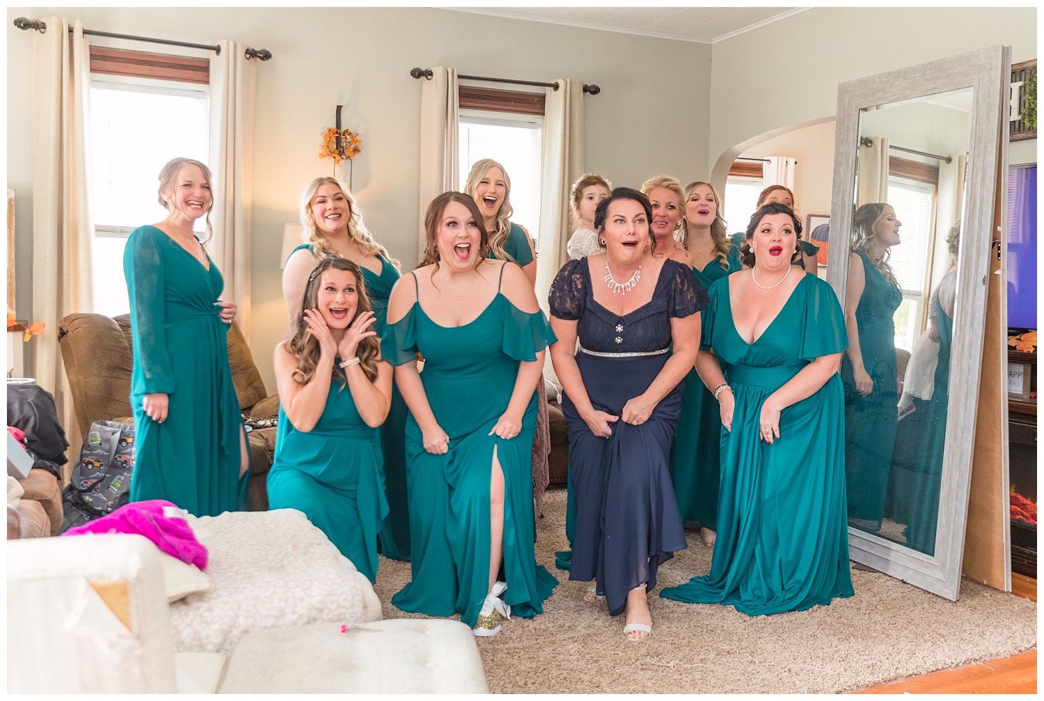 bridesmaids reacting to the bride in her dress