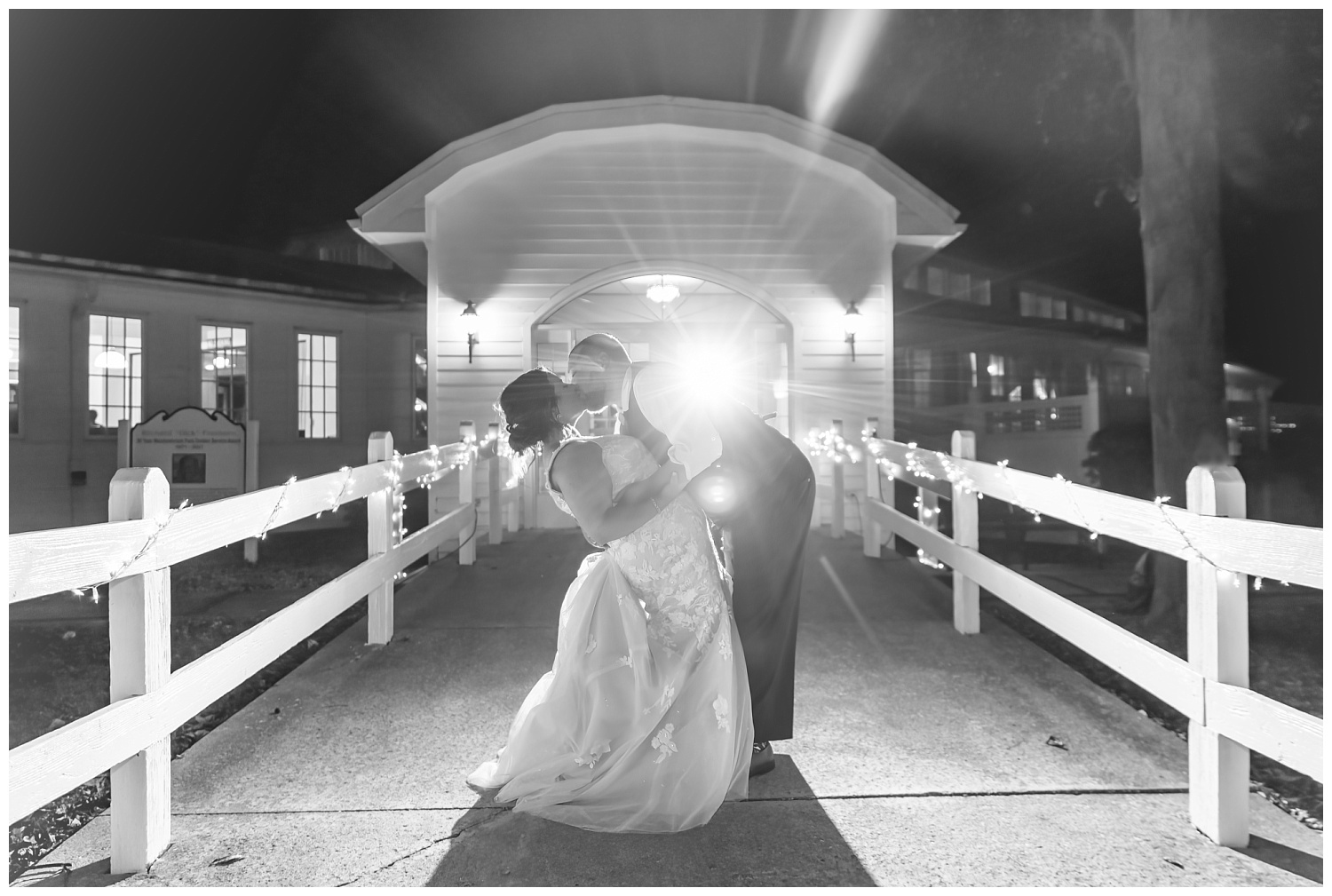 bride and groom kissing at the front entrance at dark at Meadowview Park