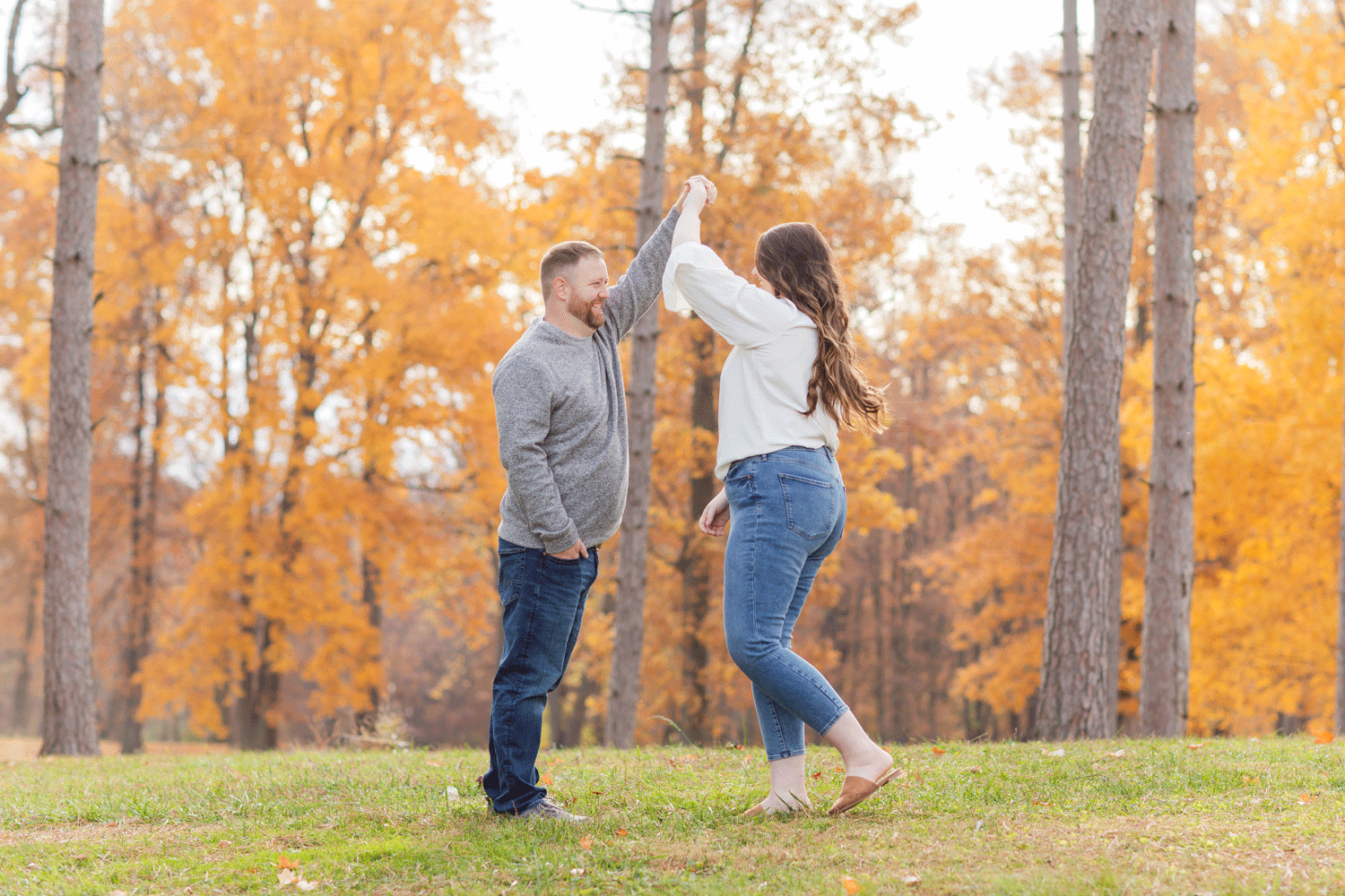 engaged couple twirling during session in northwest Ohio