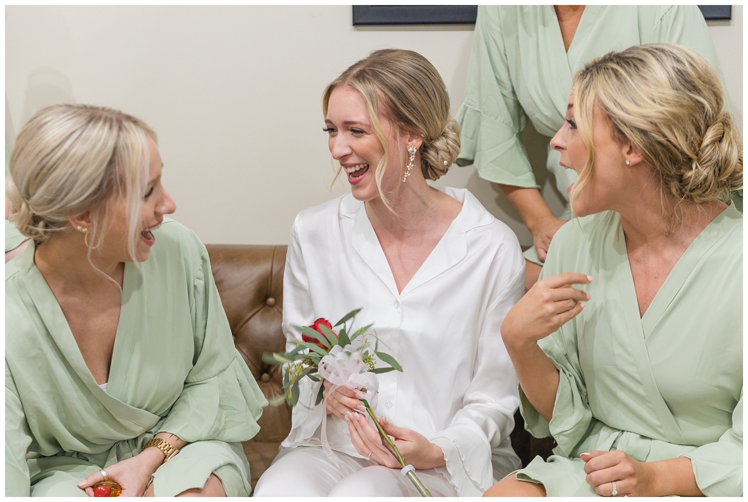 bride laughing with girls while getting rady