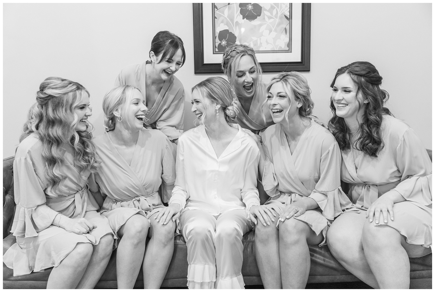 bridesmaids laughing together while getting ready
