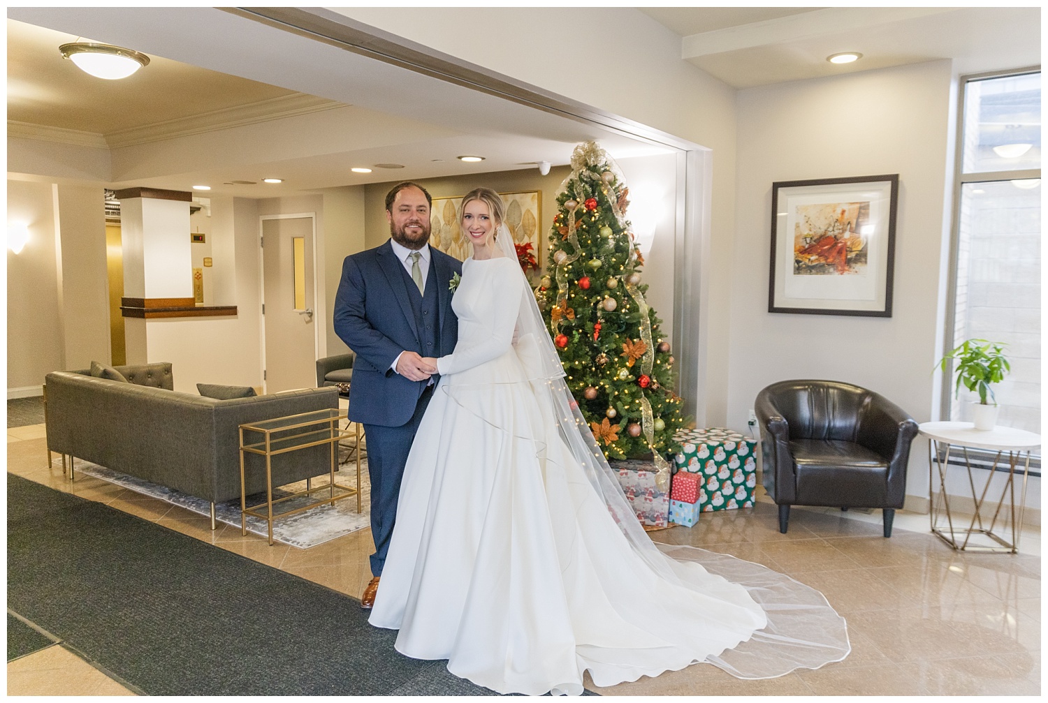 bride and groom standing in front of a Christmas Tree at Ohio wedding venue