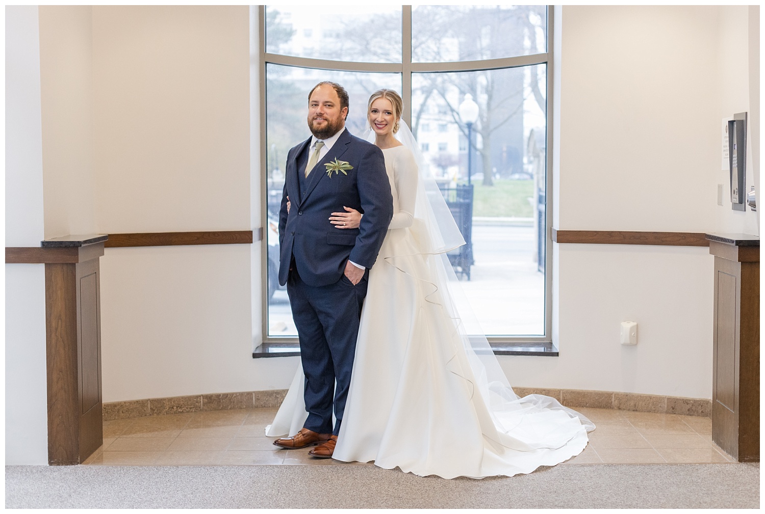 bride and groom standing in front of big windows in Columbus, Ohio