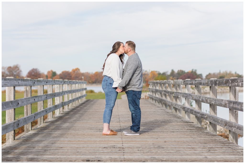 engaged couple kissing on the bridge at Norwalk Reservoir in Ohio