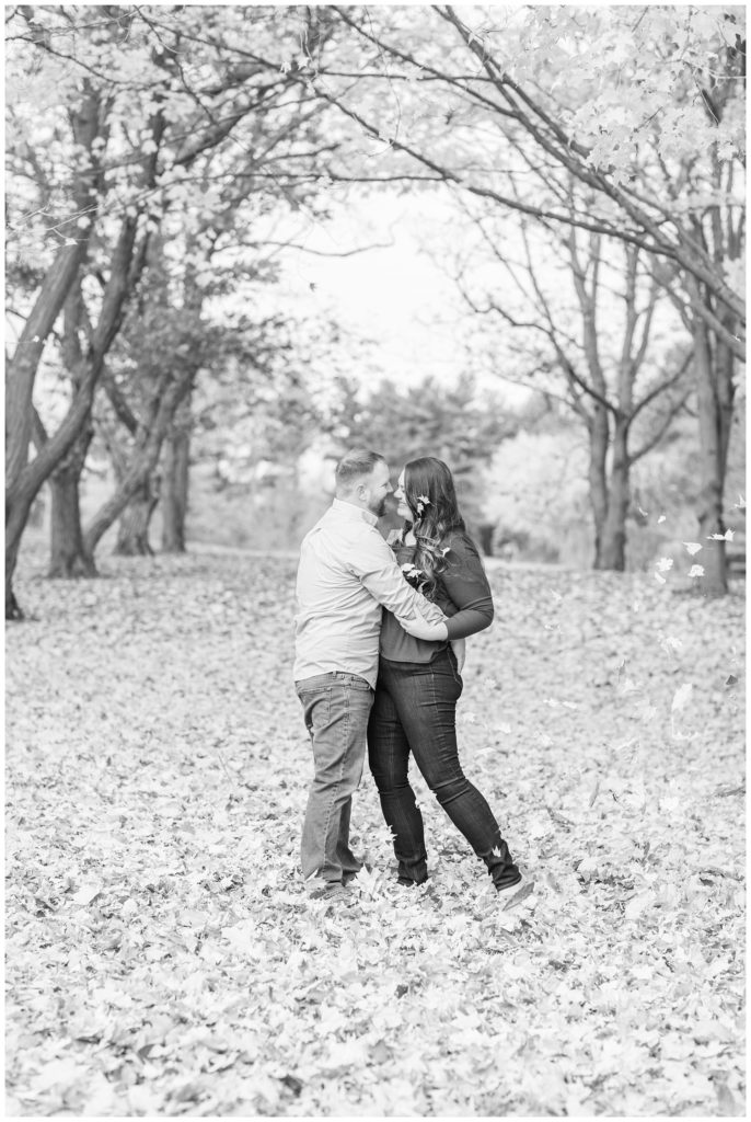 couple kissing at fall engagement session in northwest Ohio
