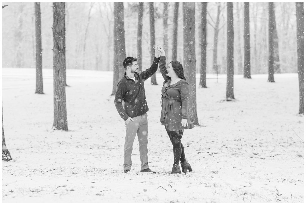 engaged couple dancing in the snow in Norwalk, Ohio