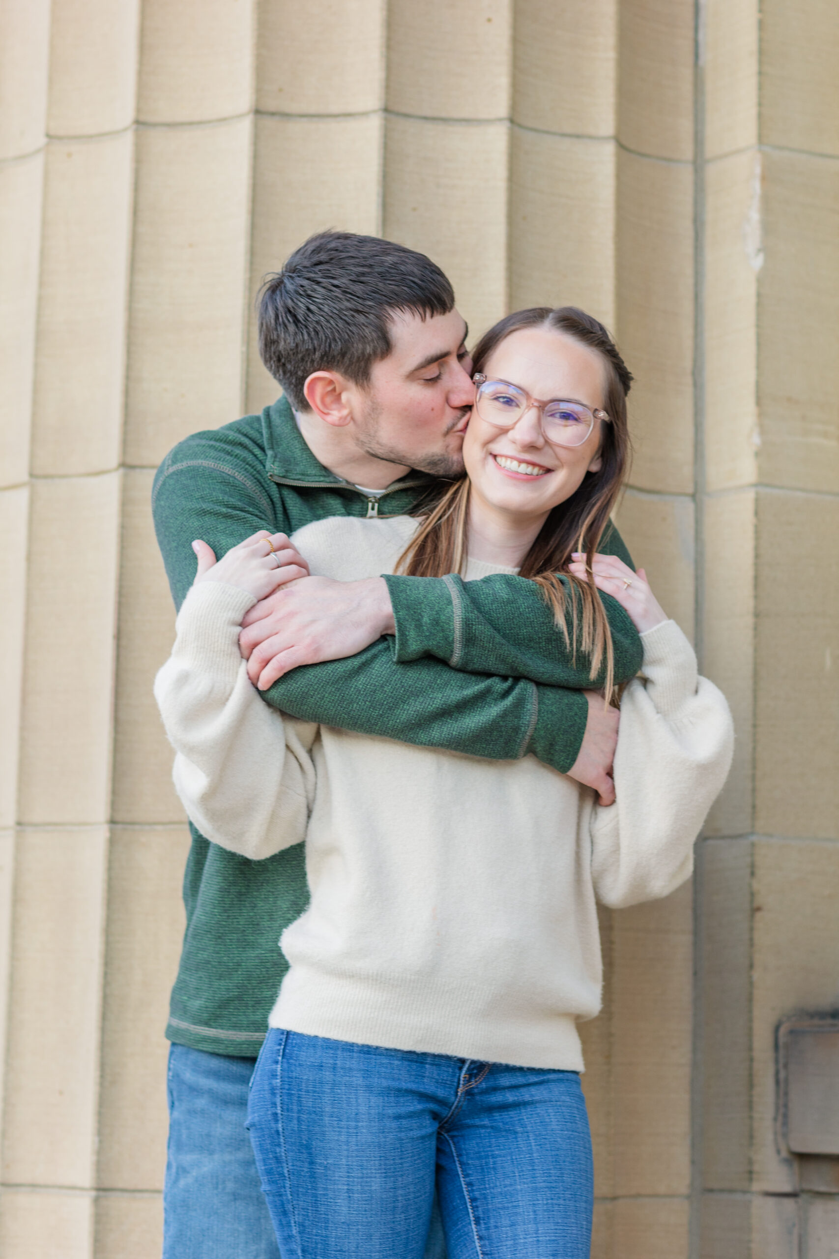 couple hugging in front of a column in downtown Tiffin