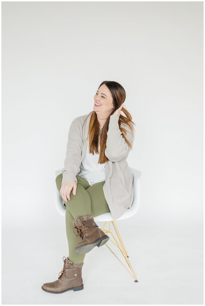 small business owner sitting on a stool at studio branding session