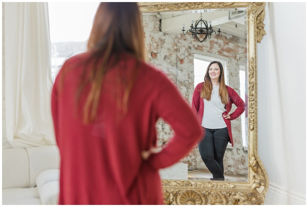 female entrepreneur posing in a mirror for branding session