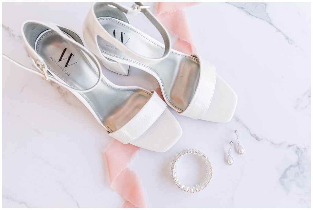 white wedding heels sitting next to a bracelet and earrings at downtown Tiffin ceremony